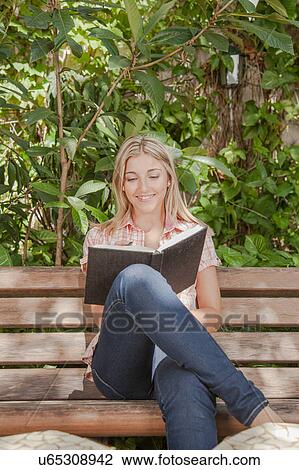 Pretty woman reading a book in the park View Large Photo Image Stock Image - Pretty woman reading a book in the park. Fotosearch