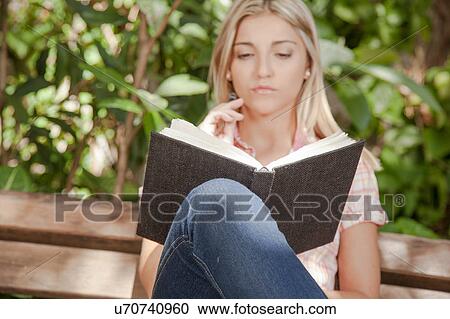 Pretty woman reading a book in the park View Large Photo Image Stock Image - Pretty woman reading a book in the park. Fotosearch