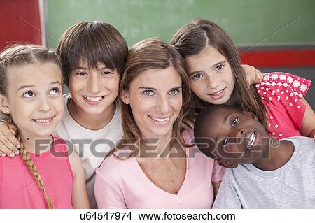 Picture - Pupils and teacher looking at camera and smiling. Fotosearch