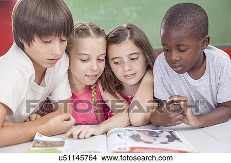 Picture - Pupils reading togethers. Fotosearch