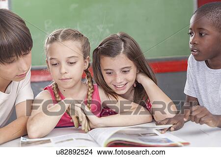 Picture - Pupils reading togethers. Fotosearch