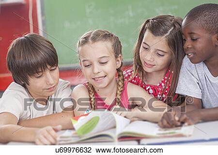 Stock Image - Pupils reading togethers. Fotosearch