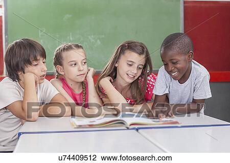 Stock Image - Pupils reading togethers. Fotosearch