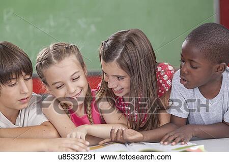 Pupils reading togethers View Large Photo Image Stock Image - Pupils reading togethers. Fotosearch