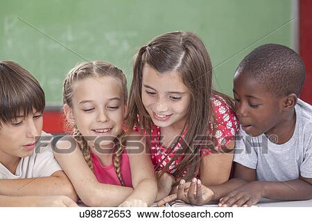 Stock Image - Pupils reading togethers. Fotosearch