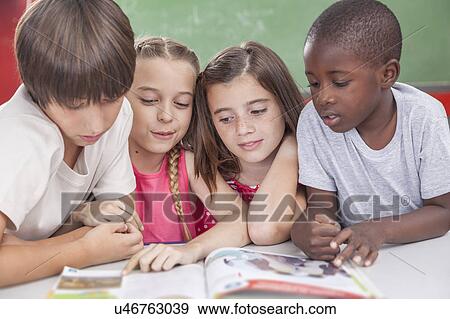 Stock Photo - Pupils reading togethers. Fotosearch