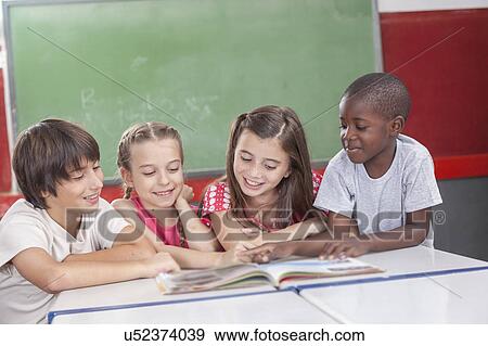 Stock Photo - Pupils reading togethers. Fotosearch