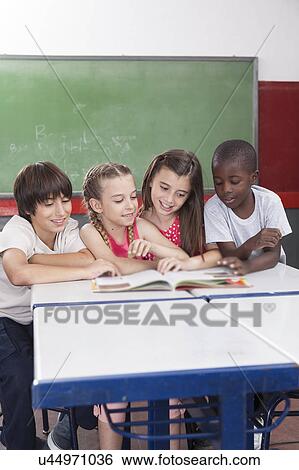 Stock Photograph - Pupils reading togethers. Fotosearch