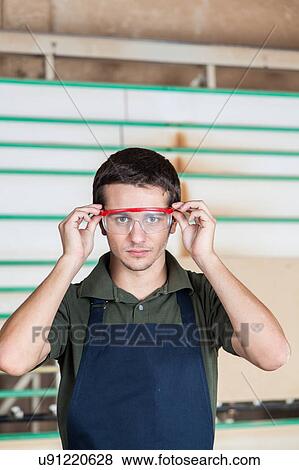Stock Photo - Serious Carpenter with glasses. Fotosearch