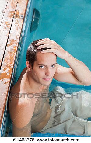 Serious man resting in the edge of the pool View Large Photo Image Stock Photograph - Serious man resting in the edge of the pool. Fotosearch