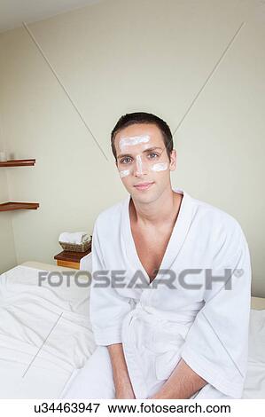 Serious man sitting with cream on her face View Large Photo Image Stock Photo - Serious man sitting with cream on her face. Fotosearch