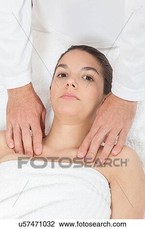 Serious woman getting massage View Large Photo Image Stock Image - Serious woman getting massage. Fotosearch