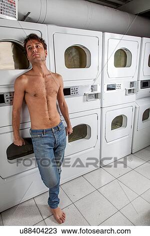 Stock Image - Sexy man waiting for clothes. Fotosearch