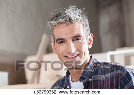 Stock Image - Smiling carpenter. Fotosearch