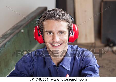 Smiling carpenter with headphones View Large Photo Image Stock Image - Smiling carpenter with headphones. Fotosearch