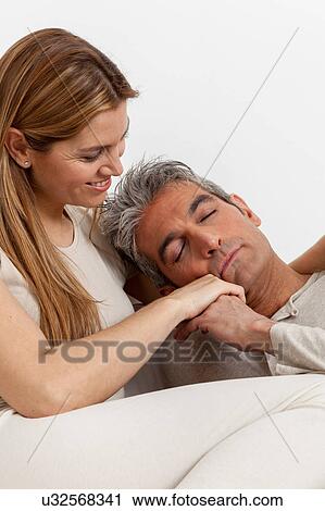 Stock Image - Smiling couple in the bed . Fotosearch