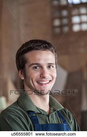 Smiling man in his workshop View Large Photo Image Stock Image - Smiling man in his workshop. Fotosearch