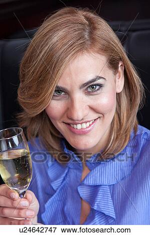 Stock Photo - Smiling woman making a toast. Fotosearch