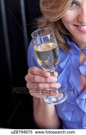 Stock Photography - Smiling woman making a toast. Fotosearch