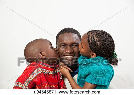 Son and daughter kissing her father View Large Photo Image Stock Image - Son and daughter kissing her father. Fotosearch