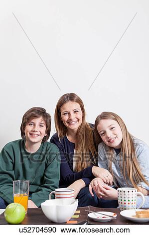 Sons giving a surprise to her mother View Large Photo Image Stock Image - Sons giving a surprise to her mother. Fotosearch