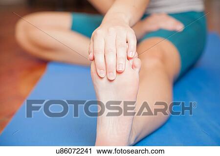Stock Image - Stretching her foot. Fotosearch