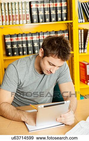 Stock Photo - Student in his desk. Fotosearch