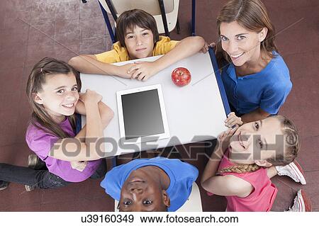 Students and teacher looking at camera View Large Photo Image Stock Photo - Students and teacher looking at camera. Fotosearch
