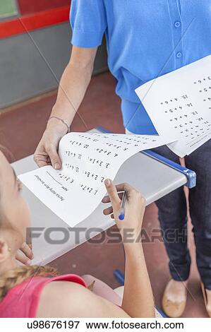 Stock Photo - Teacher giving the exam. Fotosearch