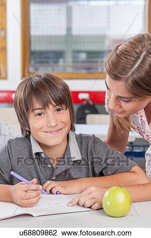 Teacher helping a boy View Large Photo Image Stock Image - Teacher helping a boy. Fotosearch