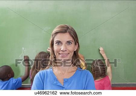 Teacher looking at camera View Large Photo Image Stock Image - Teacher looking at camera. Fotosearch
