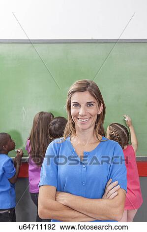 Stock Image - Teacher looking at camera. Fotosearch