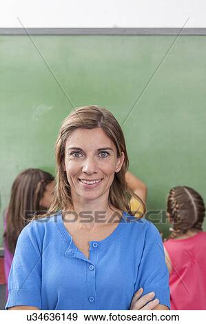 Teacher looking at camera View Large Photo Image Stock Photo - Teacher looking at camera. Fotosearch