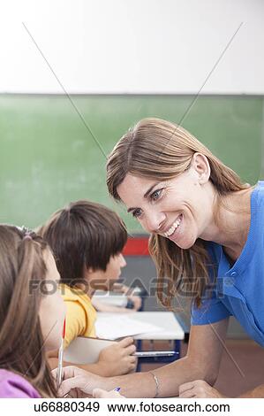 Teacher looking at pupil View Large Photo Image Stock Photo - Teacher looking at pupil. Fotosearch
