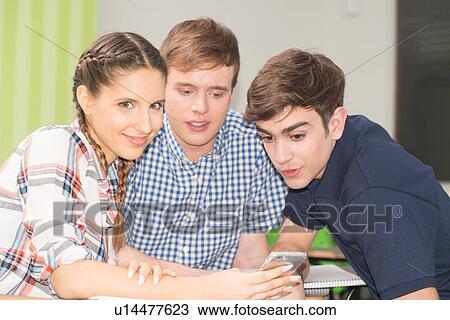 Stock Image - Teenagers in school. Fotosearch