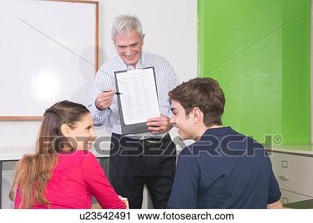 Stock Image - Teenagers in the college. Fotosearch