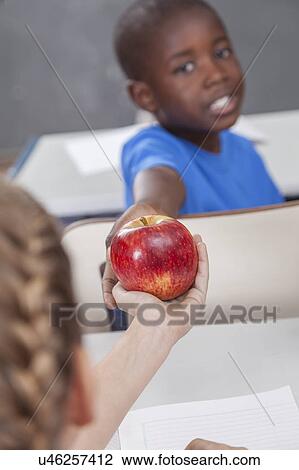 The boy giving an apple View Large Photo Image Stock Image - The boy giving an apple. Fotosearch