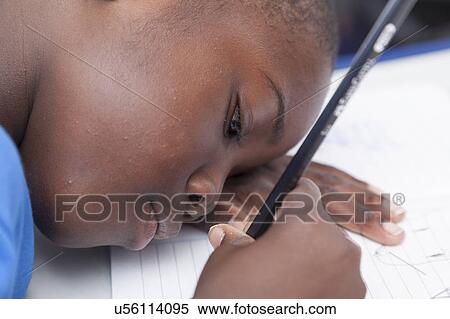 The boy writing in his notebook View Large Photo Image Stock Photography - The boy writing in his notebook. Fotosearch