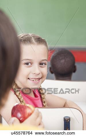 Picture - The girl giving an apple. Fotosearch