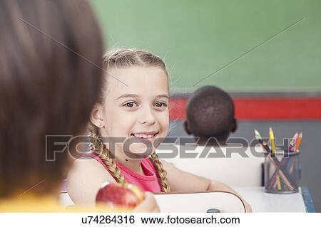 The girl giving an apple View Large Photo Image Stock Photograph - The girl giving an apple. Fotosearch