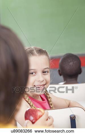 The girl giving an apple View Large Photo Image Stock Photograph - The girl giving an apple. Fotosearch