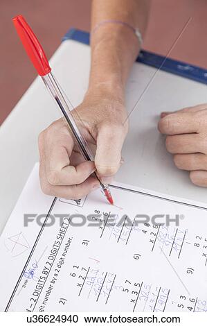 Stock Image - the teacher checking the homework. Fotosearch
