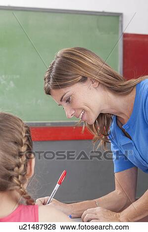 The teacher checking the homework View Large Photo Image Stock Photo - The teacher checking the homework. Fotosearch