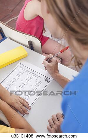 The teacher checking the homework View Large Photo Image Stock Photo - The teacher checking the homework. Fotosearch