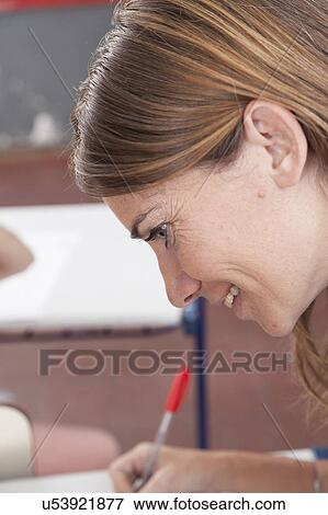 Stock Photo - The teacher checking the homework. Fotosearch