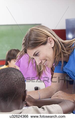the teacher checking the homework View Large Photo Image Stock Photograph - the teacher checking the homework. Fotosearch