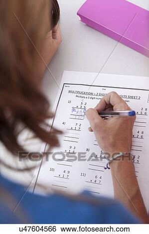 Stock Photograph - The teacher checking the homework. Fotosearch
