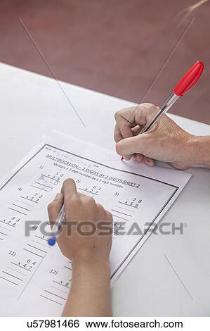 The teacher checking the homework View Large Photo Image Stock Photograph - The teacher checking the homework. Fotosearch