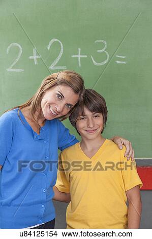 The teacher giving a hug to her pupil View Large Photo Image Picture - The teacher giving a hug to her pupil. Fotosearch