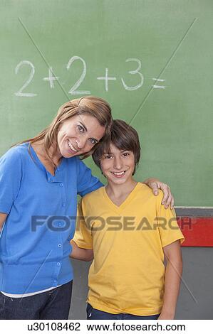 The teacher giving a hug to her pupil View Large Photo Image Stock Image - The teacher giving a hug to her pupil. Fotosearch